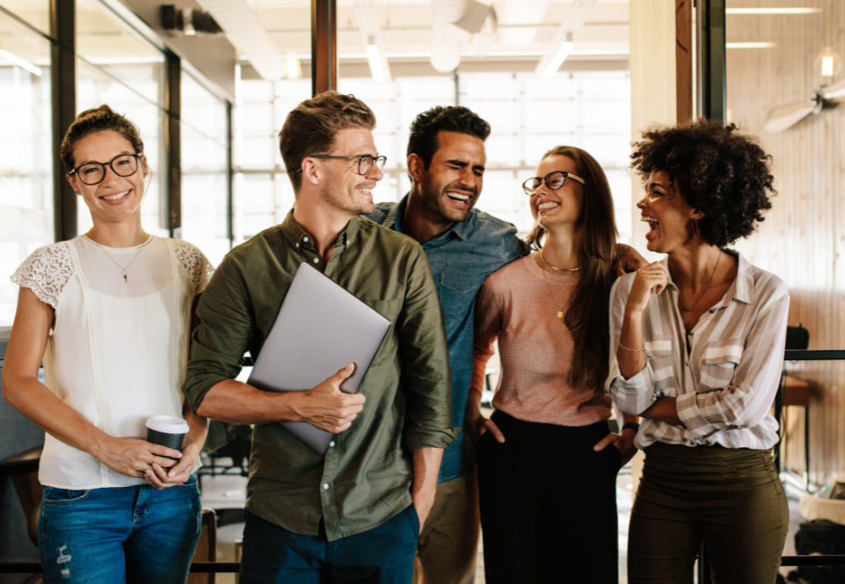 office workers standing together laughing